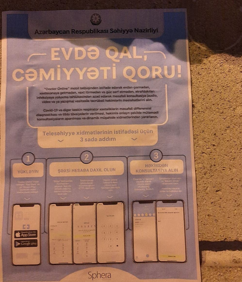 A public-health poster on a Baku wall, headed EVDƏ QAL, CƏMİYYƏTİ QORU in bold modern Azerbaijani Latin type above paragraphs of instructions and three numbered steps for using the telehealth app