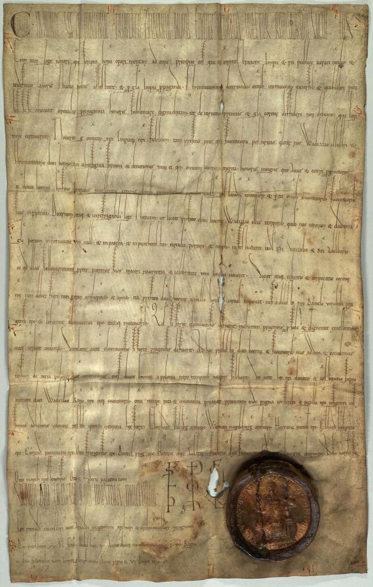 Parchment diploma of 1158 with a tall first line of stretched letters, widely spaced text, an imperial monogram and a brown wax seal