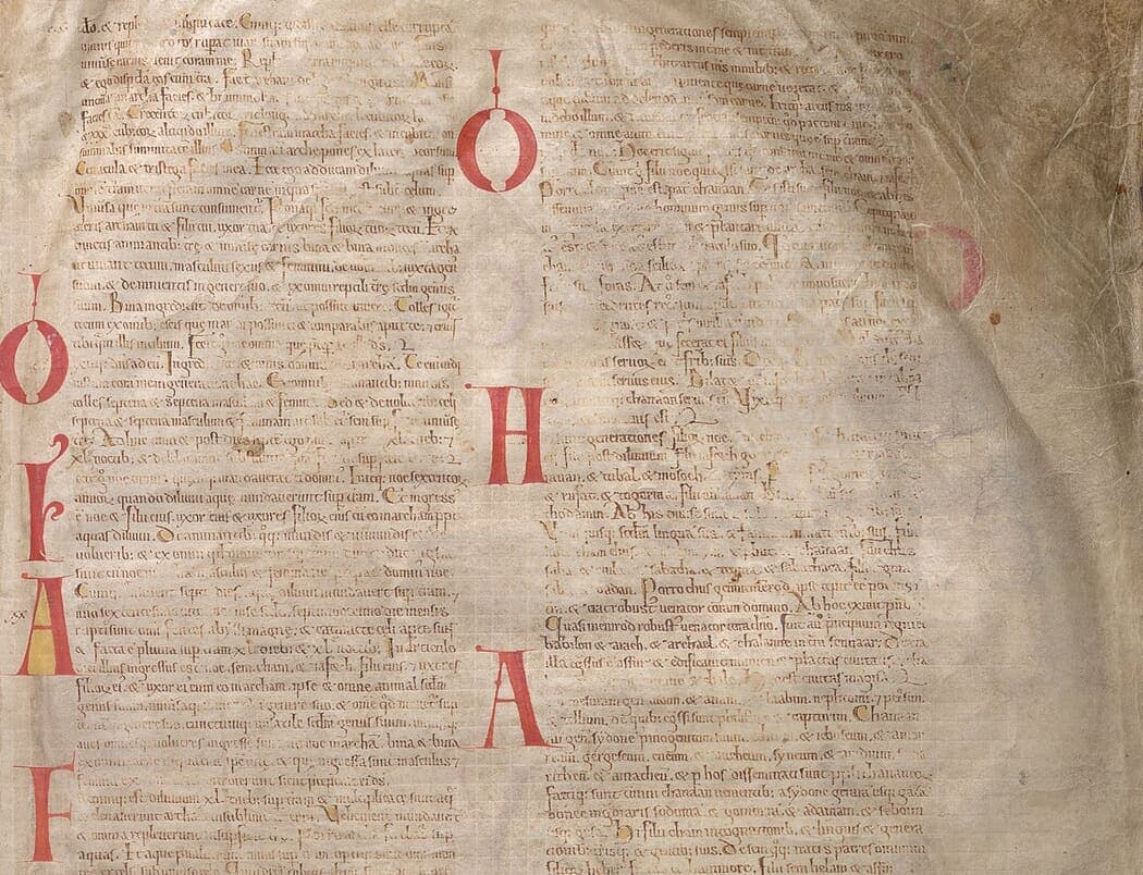 Two columns of small Gothic textualis from the Codex Gigas with a vertical row of red display initials between them