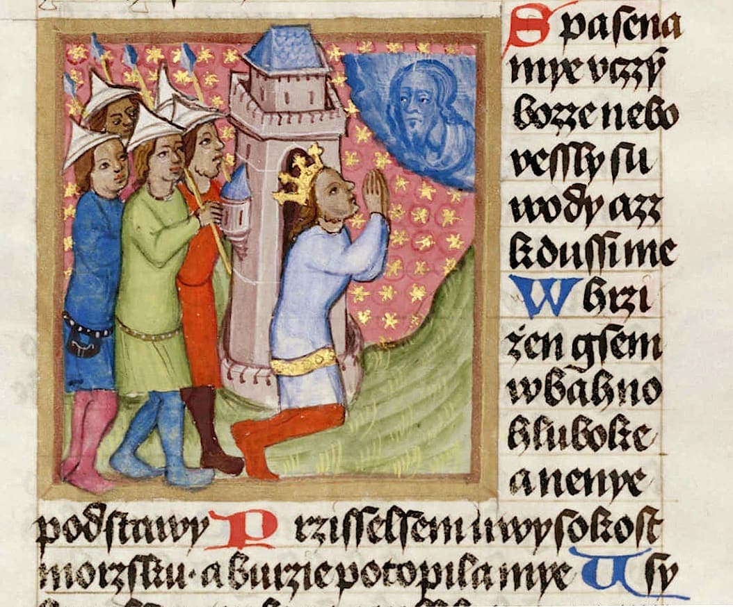 Close view of a narrow column of Gothic Czech text with blue and red initials, beside part of a miniature of a kneeling king