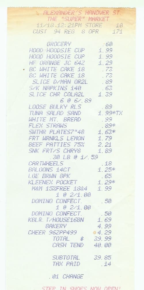 A dot-matrix supermarket till receipt listing abbreviated grocery items with prices, tax flags and a total