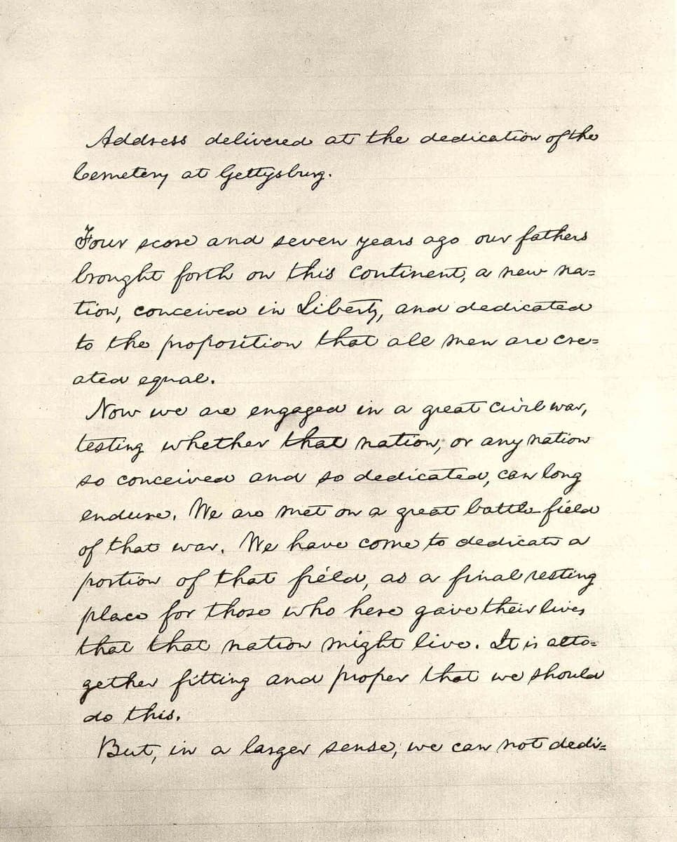 The first leaf of Lincoln’s Bliss copy of the Gettysburg Address, written in a small even hand on faintly ruled paper with “=” marks at broken words