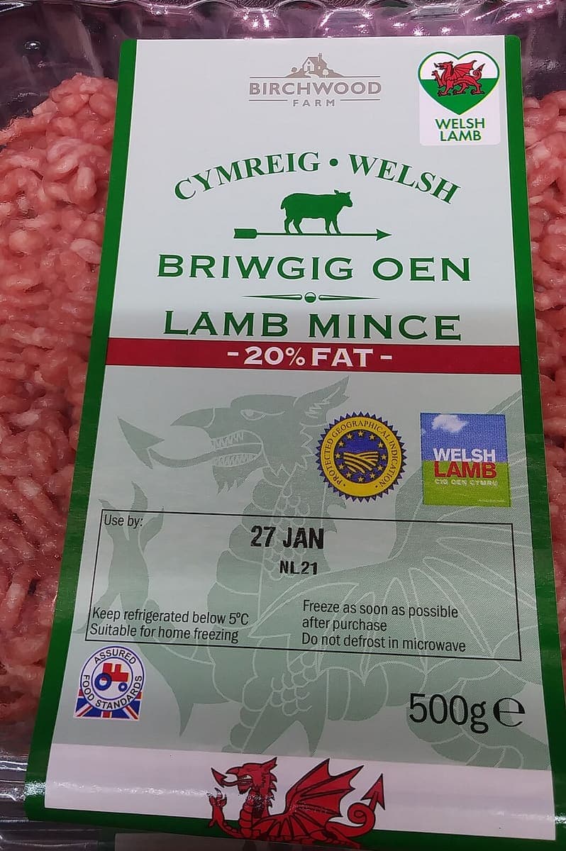 A supermarket pack of lamb mince with a bilingual Welsh and English label, a use-by box and quality marks