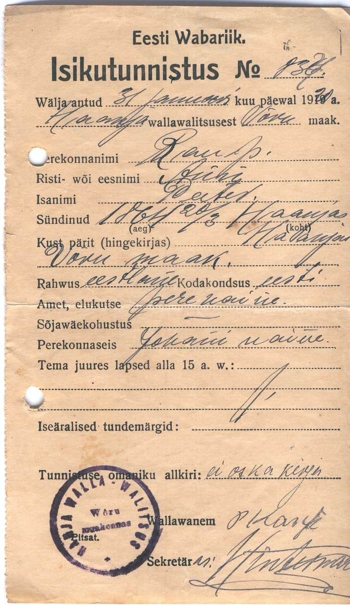Handwritten and printed 1920 Estonian identity certificate with a municipal seal and cursive personal details