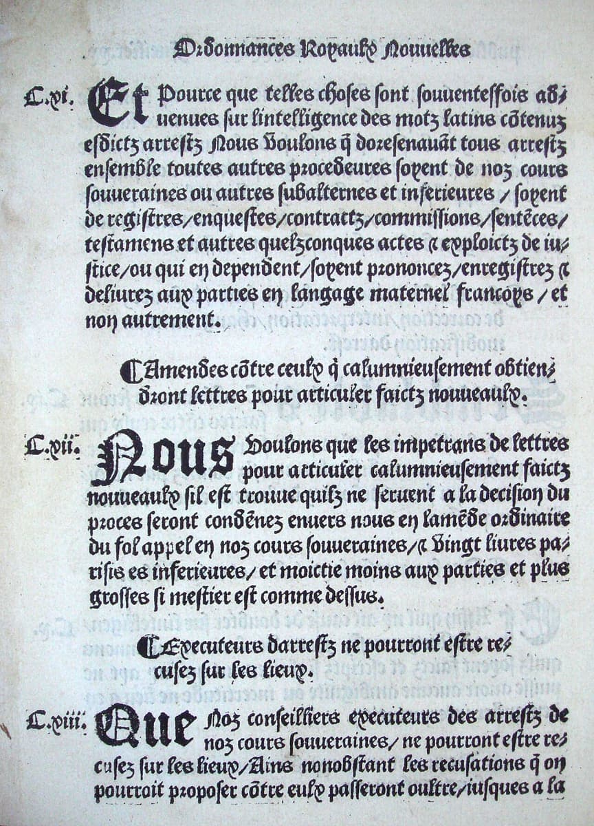 A printed page in heavy gothic type with large decorated initials, oblique strokes serving as commas and a running head in the same type