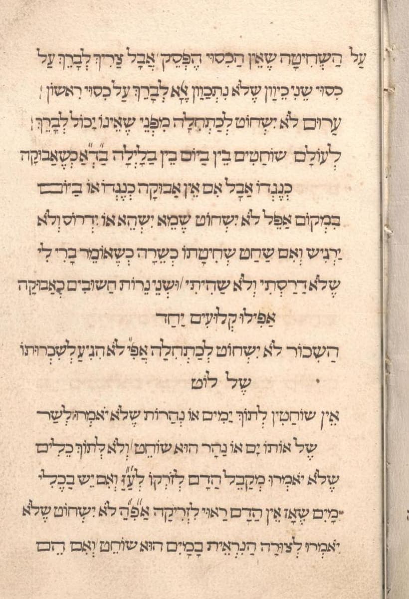 A paper page of evenly spaced Hebrew lines in a rounded hand, every word marked with vowel points, with short centred lines between paragraphs