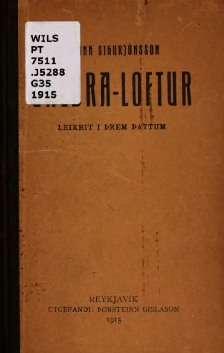 Worn brown cardboard cover of a 1915 Icelandic play, GALDRA-LOFTUR LEIKRIT Í ÞREM ÞÁTTUM, with an old library shelfmark sticker over part of the title