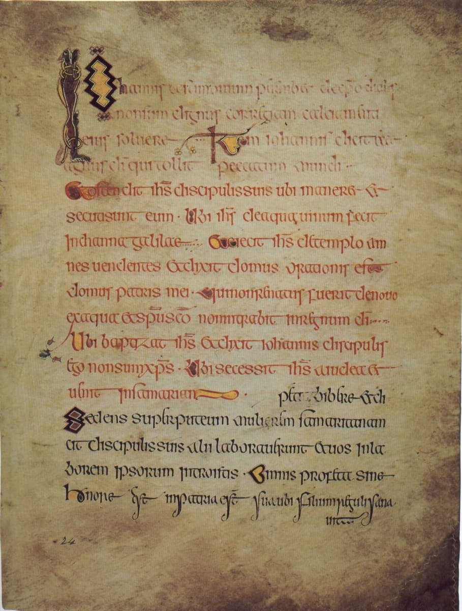 Manuscript page of rounded Insular majuscule headed by a tall zoomorphic initial, each short summary opening with a coloured initial
