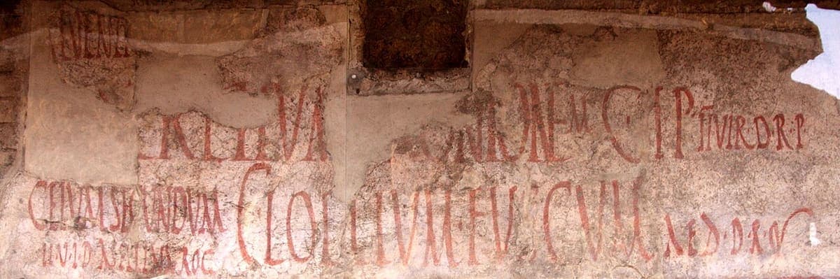 Red-painted electoral slogan in Roman capitals on a plastered house wall on the Via dell’Abbondanza at Pompeii