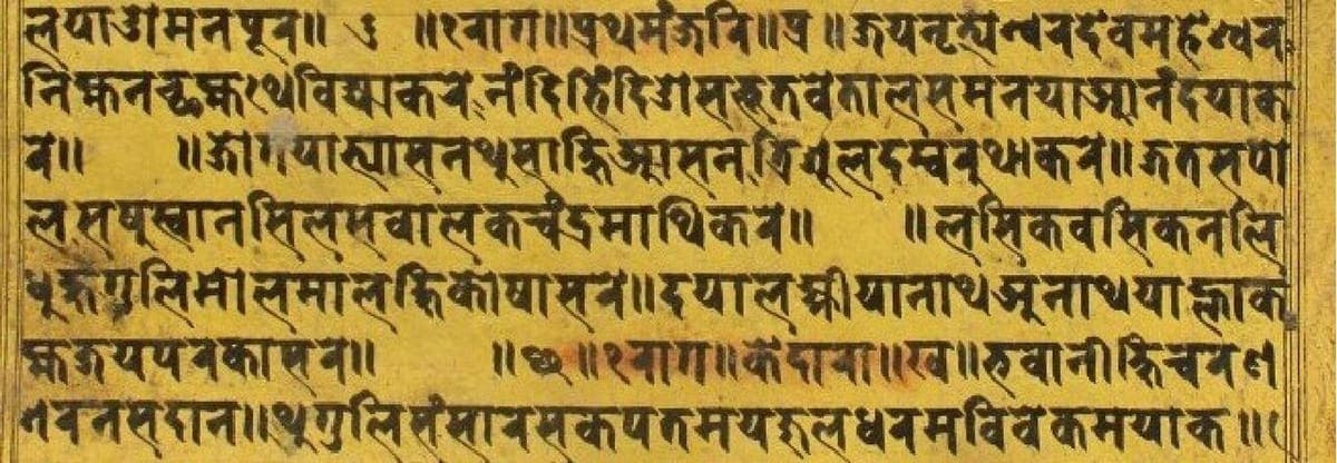 A long, narrow manuscript page stained deep yellow, filled edge to edge with seven lines of black Newar script and a few marks and headings picked out in red