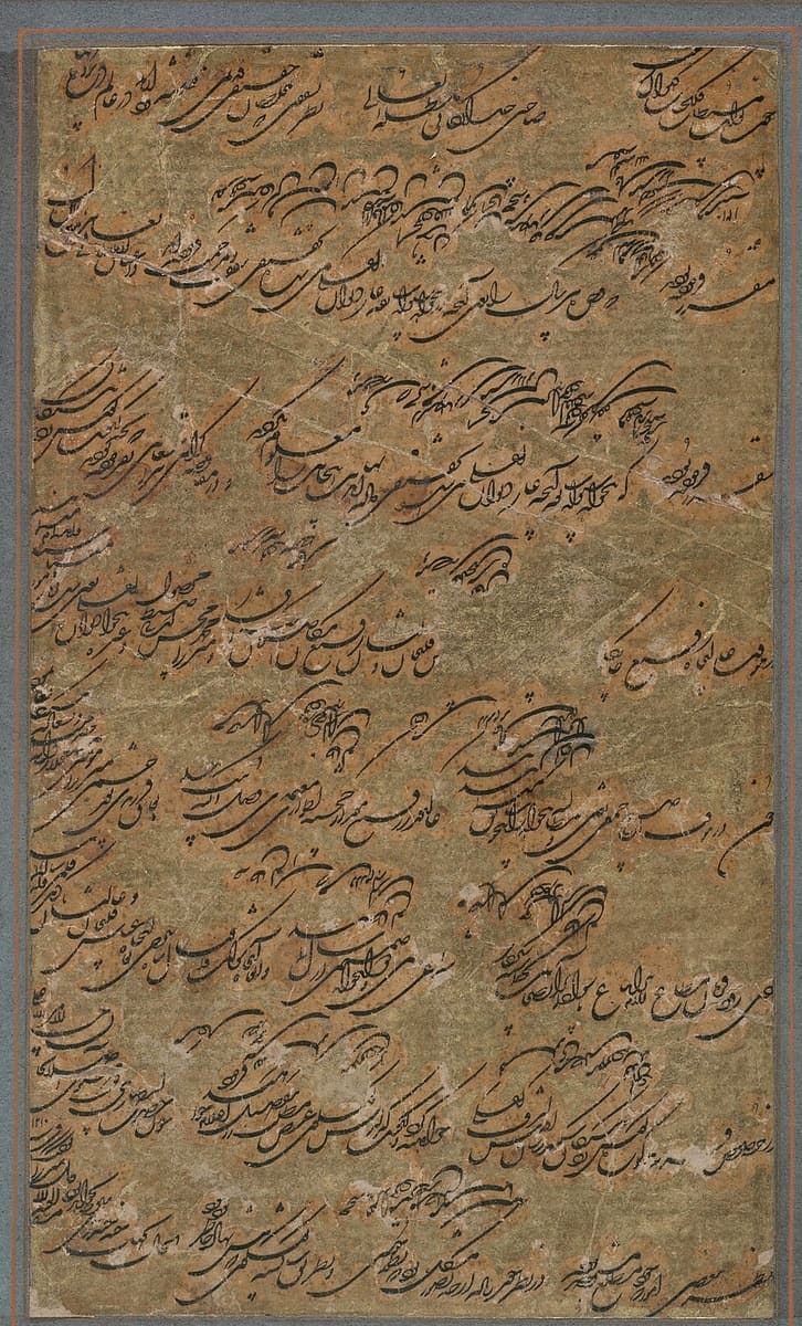 A worn brown sheet covered with long sweeping lines of Persian, with smaller writing running vertically down the left margin