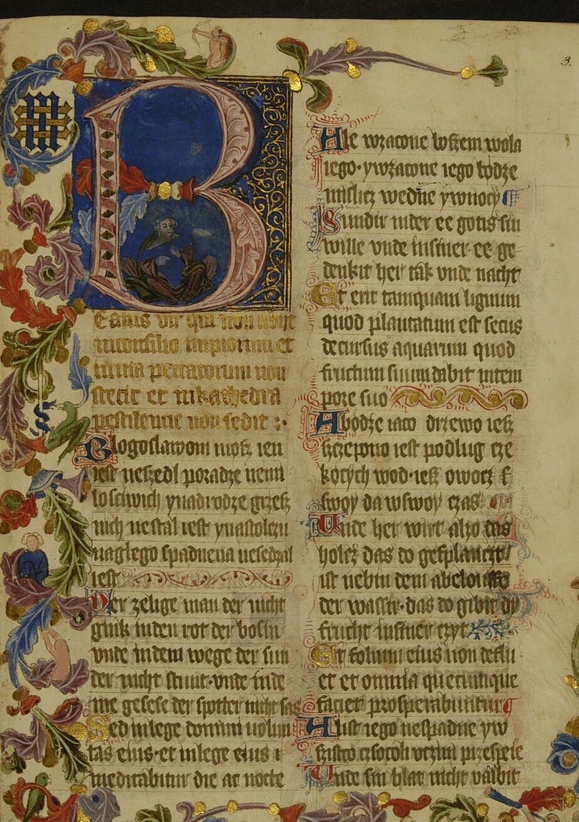 Illuminated psalter page with a large blue and gold initial B, two columns of Gothic textualis and a foliate border with animals and figures