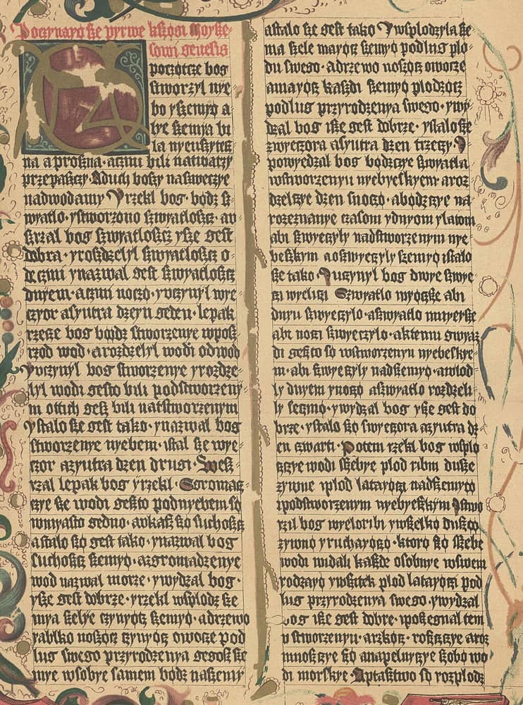 Coloured lithographic facsimile of an illuminated Bible page, two columns of Gothic script with a red rubric, a large initial and a foliate border