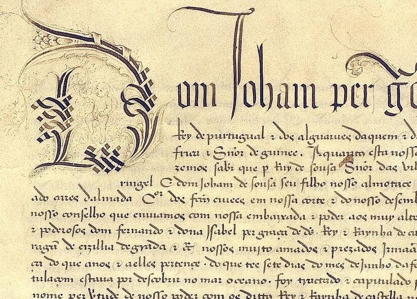 Opening of a 1494 royal instrument with a large decorated initial D and a display line beginning Dom Ioham per, the rest of the royal style continuing in a smaller chancery hand below