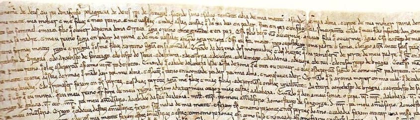 Left-hand part of the first lines of the 1214 testament of Afonso II, a small brown Gothic charter hand in very long lines