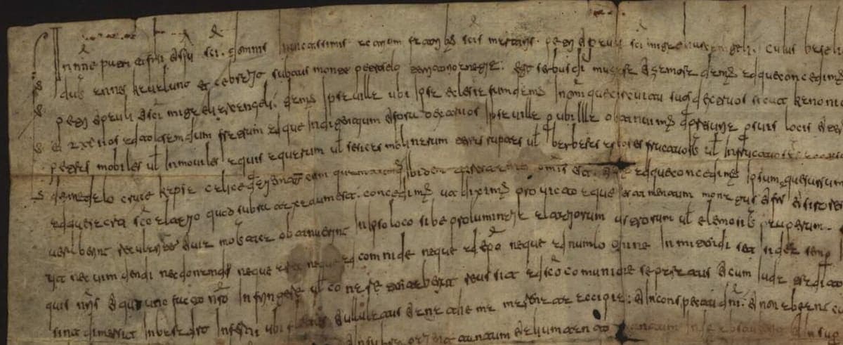 Upper left part of the 882 foundation charter of the church of Lardosa, tall Visigothic cursive in long lines on a creased parchment sheet