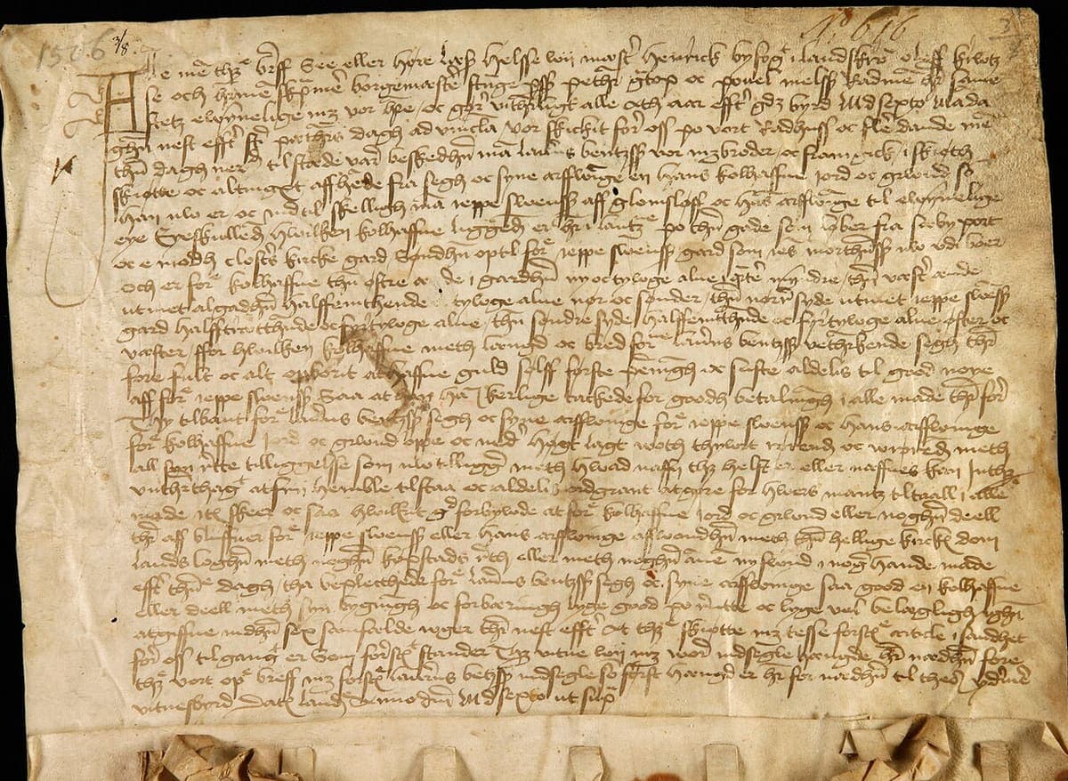 Parchment deed of 1506 with about thirty lines of early Danish Gothic cursive and a row of seal tags along the fold at the foot