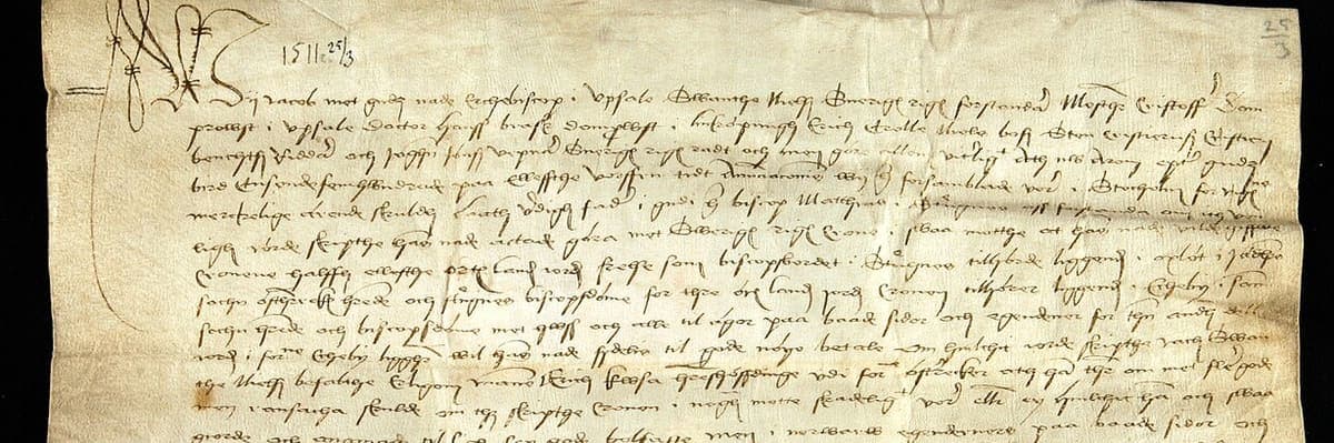 Upper part of a wide parchment charter of 1511 written in a small sloping cursive, with a date added at the head in a different ink