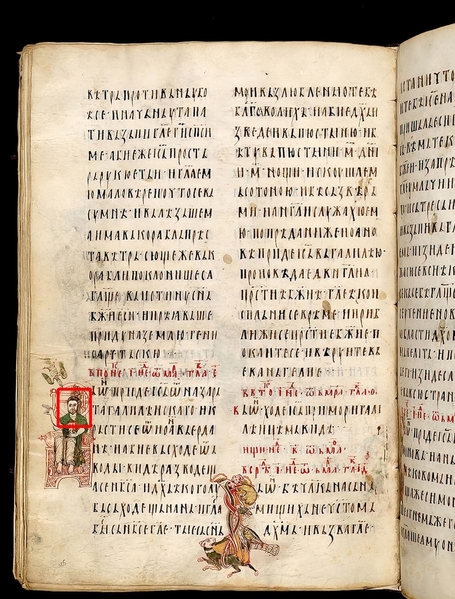 Open manuscript book with two columns of dense Cyrillic script per page, a colourful marginal miniature of a seated figure, and red rubricated headings