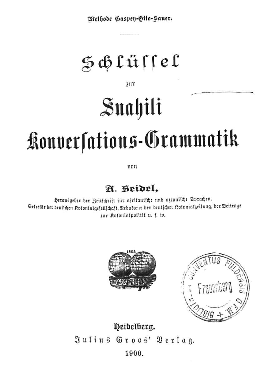 A German-language title page in blackletter type, reading Schlüssel zur Suahili Konversations-Grammatik, with a printer’s globe device and a library stamp