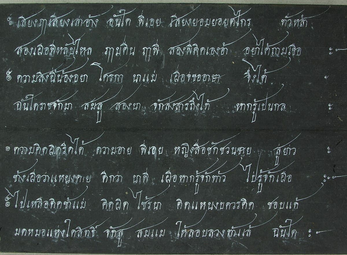 Two panels of a Thai folding-book manuscript, white ink writing in horizontal lines on blackened paper
