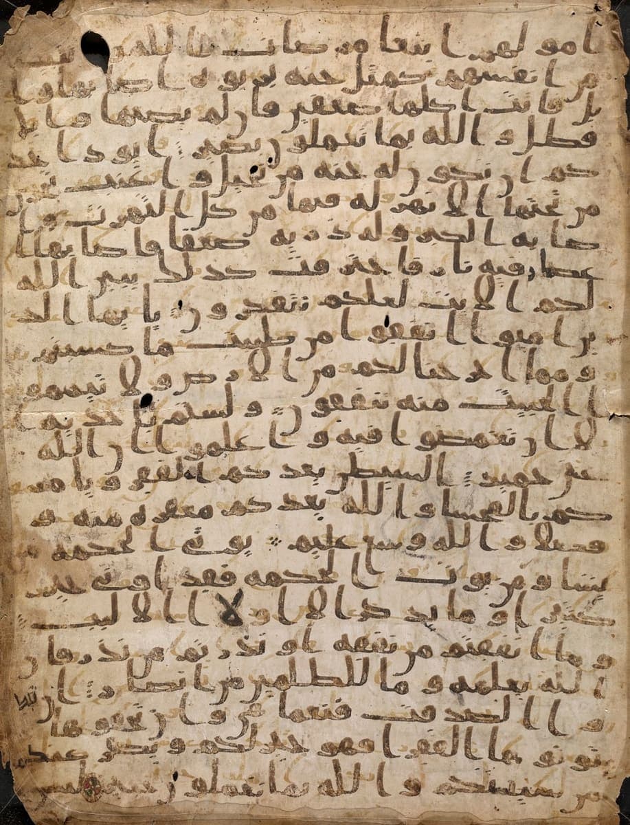 Palimpsest parchment page with dark brown upper writing and faint yellowish traces of an erased earlier text showing through between the lines