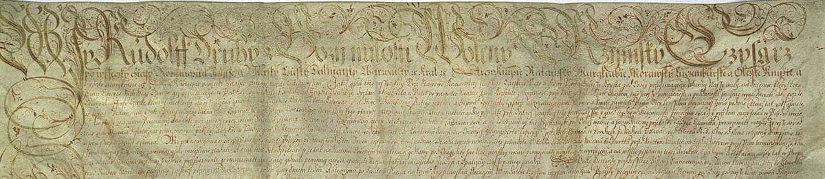Top band of a very large parchment covered in minute chancery writing, headed by a drawn opening line with pen-flourished capitals