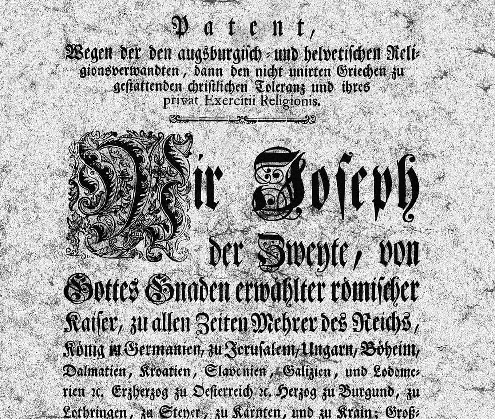 Printed patent of 1781 with a small Fraktur heading closing in a line of roman type, above an enormous decorated blackletter opening and paragraphs of German Fraktur