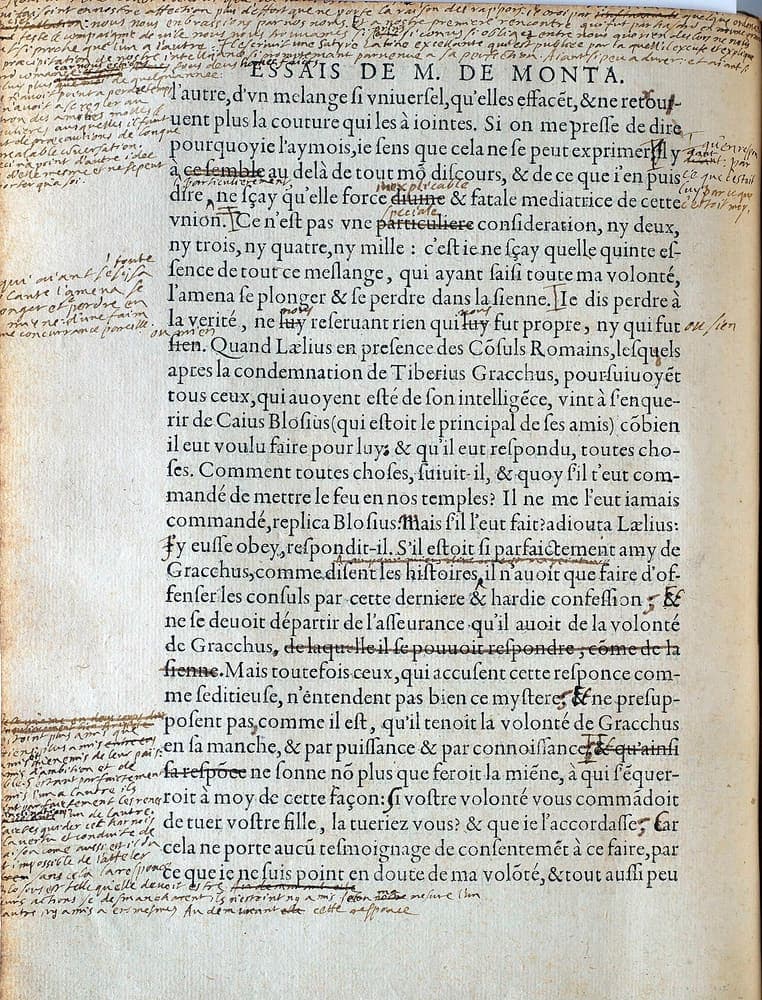 A printed book page in roman type ringed on all four sides by dense handwritten additions, with words crossed out and phrases inserted between the printed lines