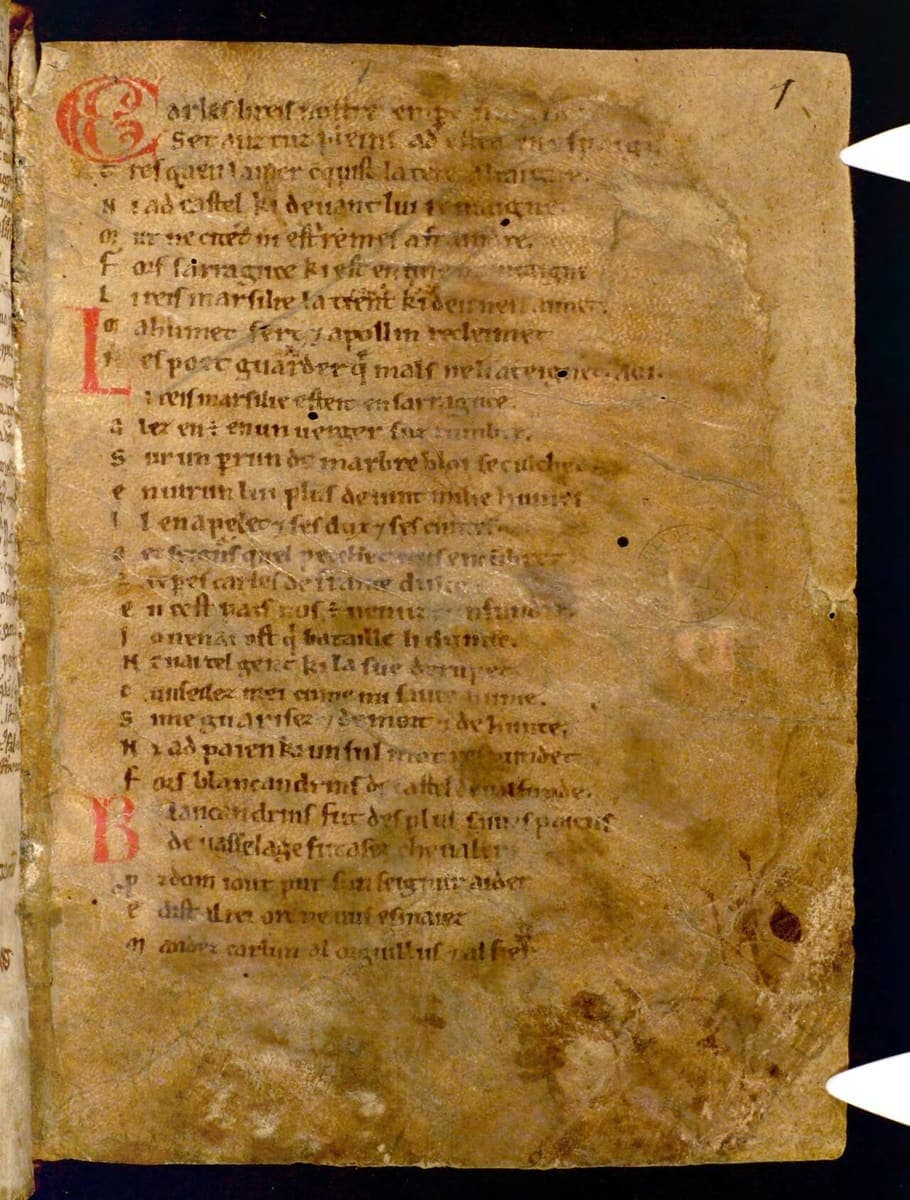 First folio of the Chanson de Roland in Bodleian MS Digby 23, browned parchment with laisse initials in red and a proto-Gothic Anglo-Norman minuscule