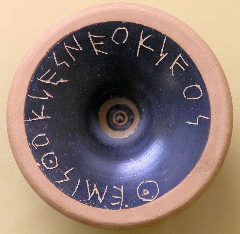 Black-glazed foot of a cup with the name of Themistocles son of Neocles scratched in a ring around the central hollow