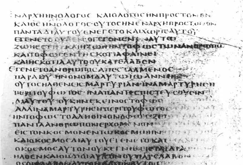 High-contrast black and white photograph of a parchment page whose Greek capitals are written in short lines of unequal length