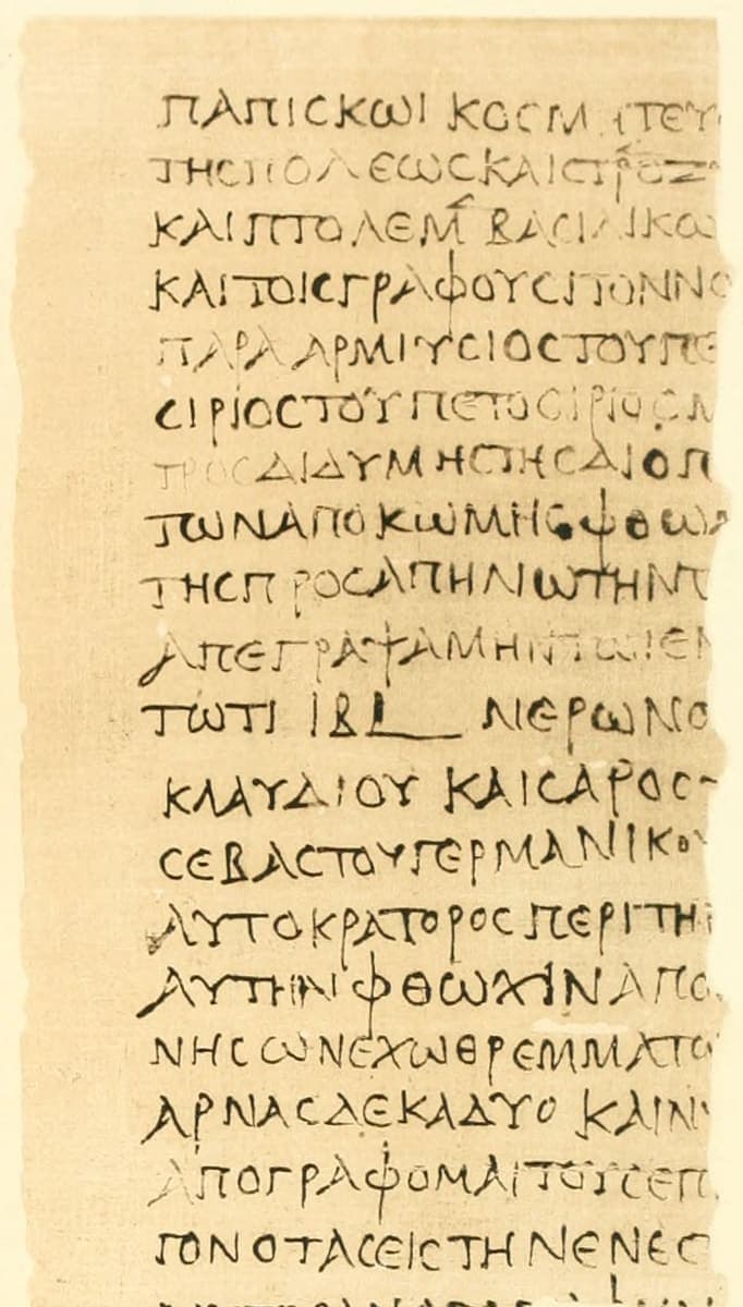 Column of large clear Greek capitals on pale papyrus, each line ending at a broken right edge