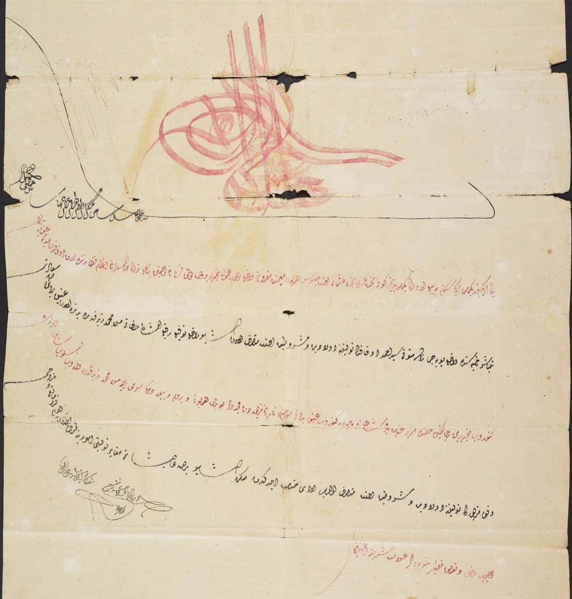 Folded Ottoman sheet with a red tughra at the top, red and black rising lines beneath it, and a column of small marginal notes down the left edge