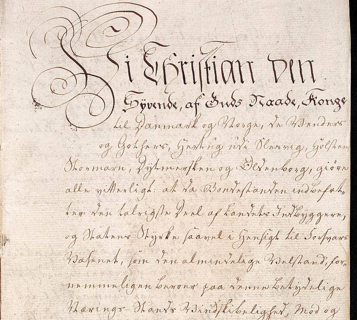 Front page of a royal ordinance of 1788 opening with the king’s style, Vi Christian den Syvende, spread over descending lines of ornamented display writing above widely spaced chancery writing