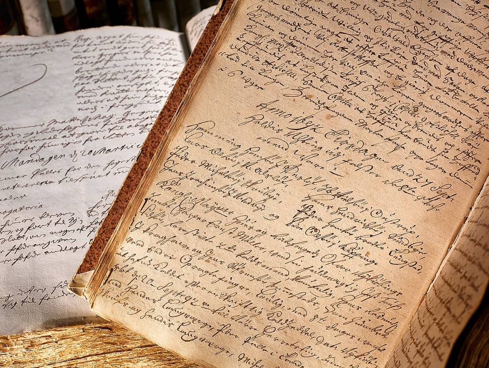 Open court book of 1692 photographed at an angle, dense brown Gothic cursive with a heading and two columns of names