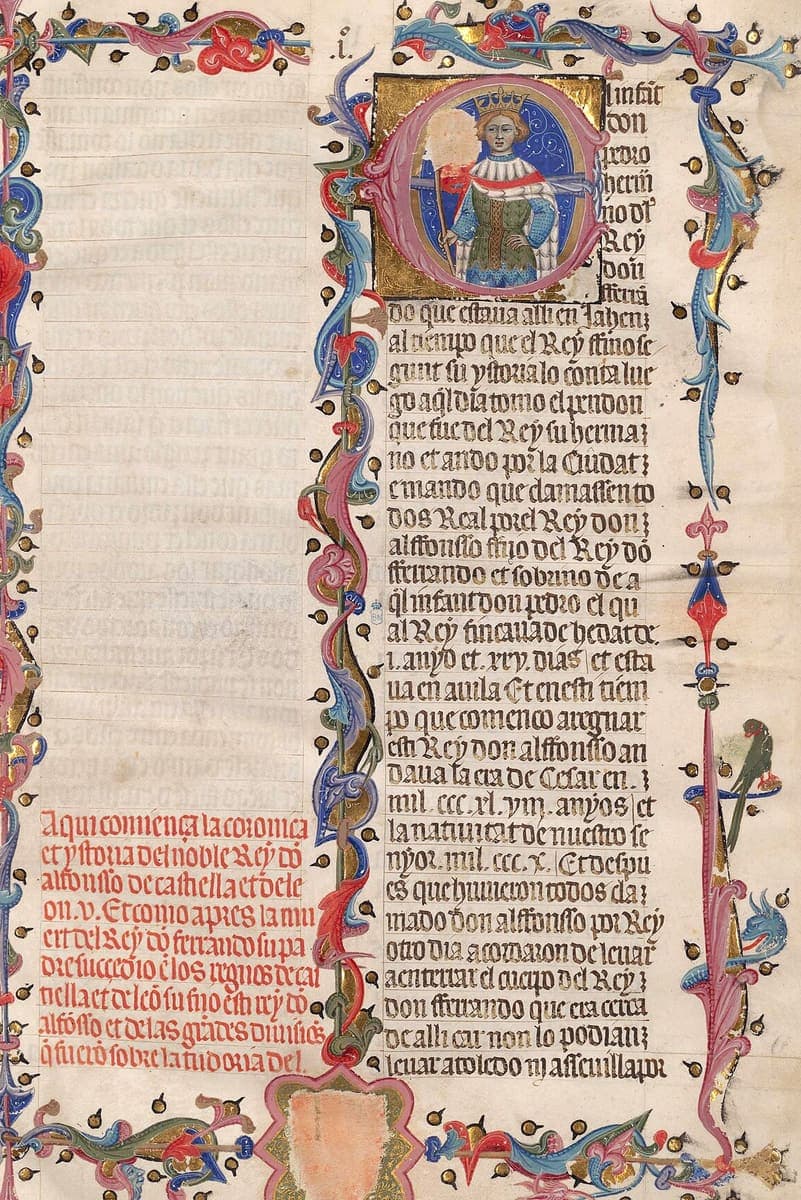 An illuminated page with a crowned king inside a gold initial, a decorated border and a column of Gothic book script.